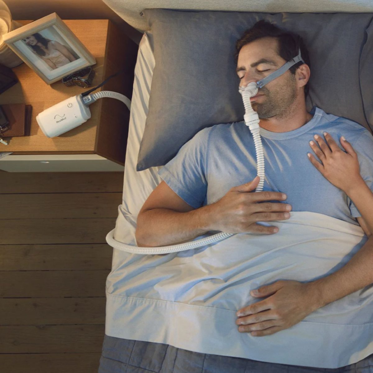 ResMed AirMini CPAP Machine being used in bed | Intus Healthcare
